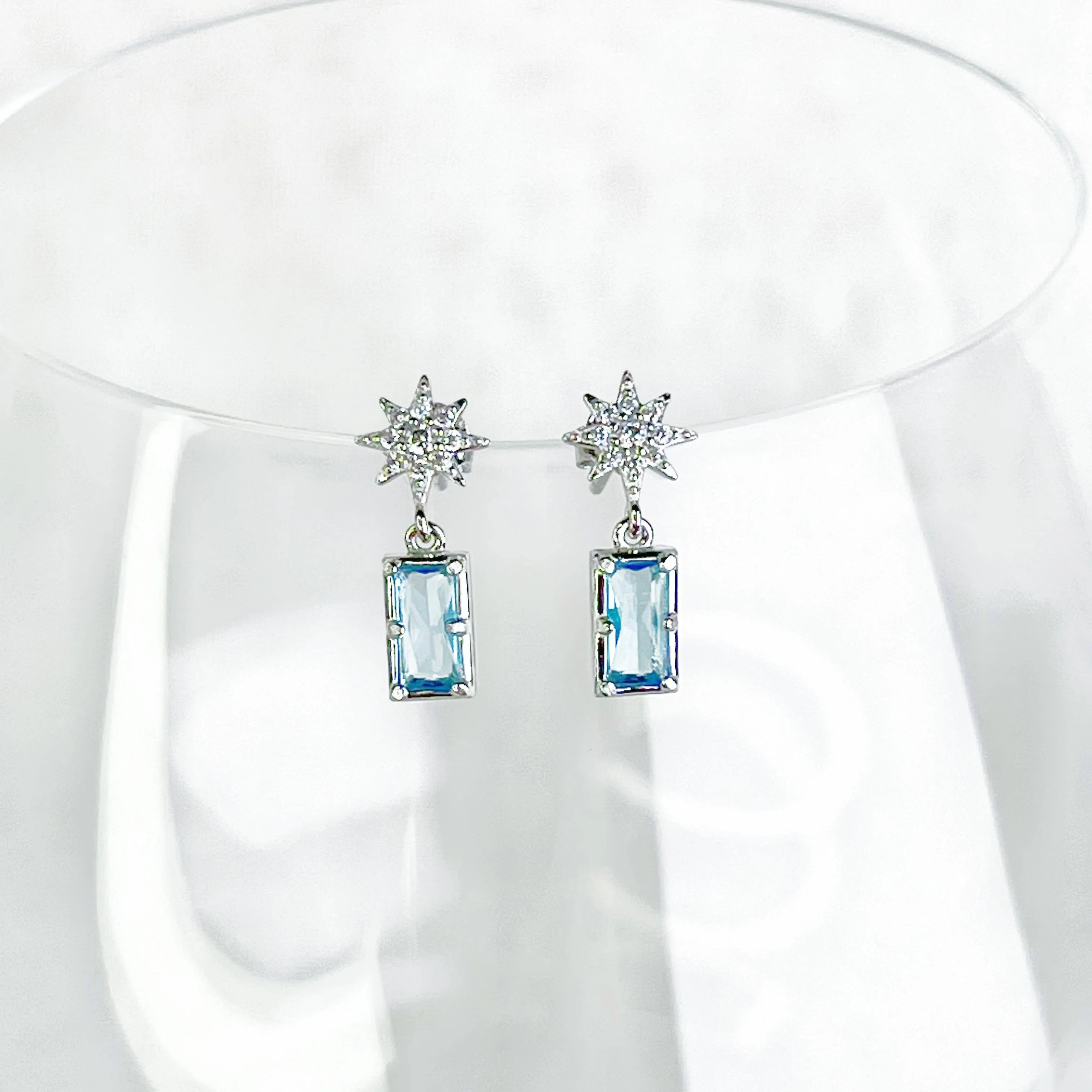 Ninaouity Silver Pole Star and Blue Square Crystal Earrings